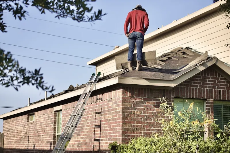 Professional roofer working on a residential roof in Remsen